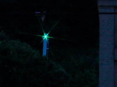 In the night, the lighthouse grows green.